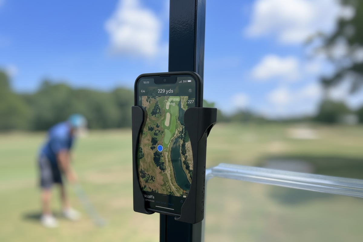 Black HoldFastPro phone holder mounted on a golf cart with a golfer in the background
