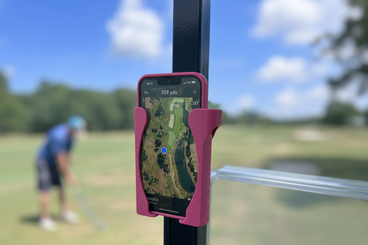 Black HoldFastPro golf cart phone holder with a golfer in the background