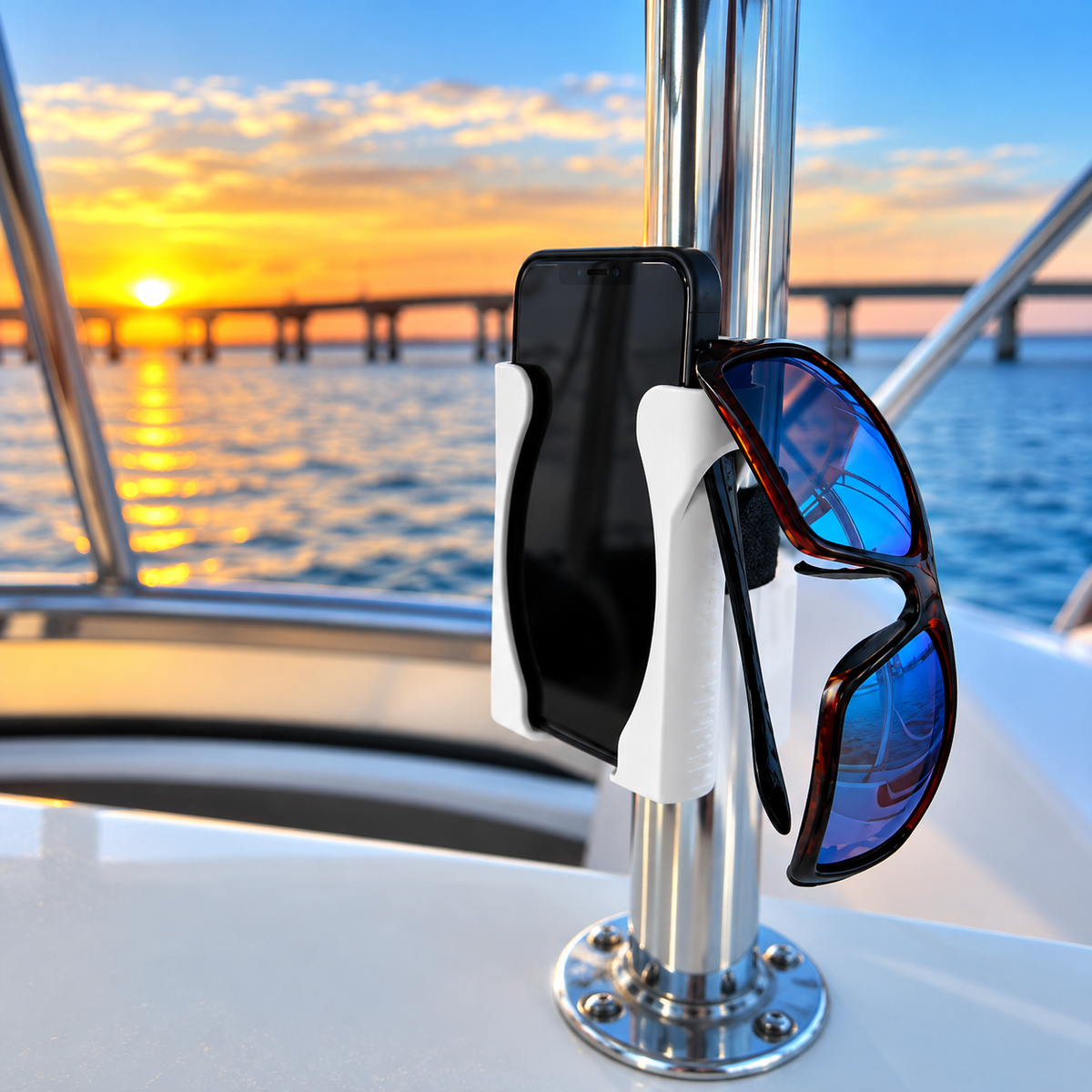 HoldFastPro boat phone holder with sunglasses mounted on vertical tubing at sunset